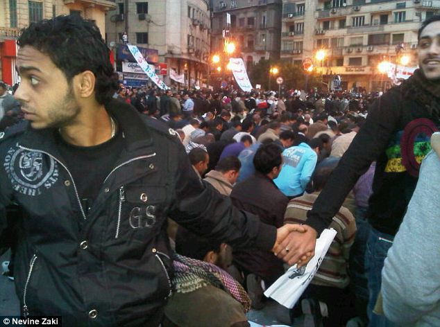 February 2011, Egypt Christians join hands to protect Muslims as they pray during Cairo protests 1