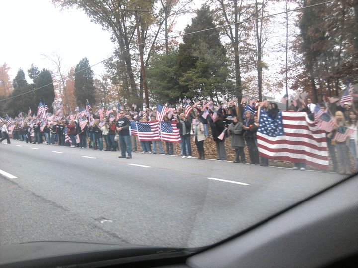 Mourners form a 5-mile barrier between a soldier's funeral and the Westboro Baptist Church [USA, 2012]