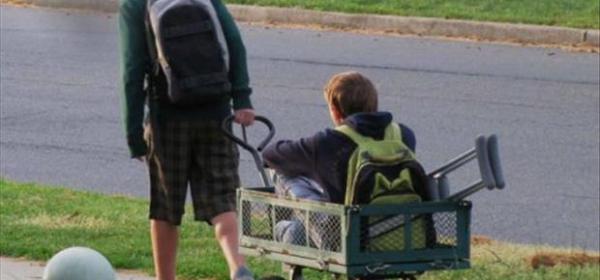 boy pulling his injured friend - kindness